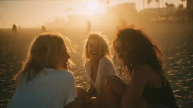 Friends hanging out on a vintage 4WD at the beach during sunset. This represents the Sunny Link™ adventure lifestyle, providing VIP access to hidden tracks and coastal spots in Brisbane, the Gold Coast, and Sunshine Coast.