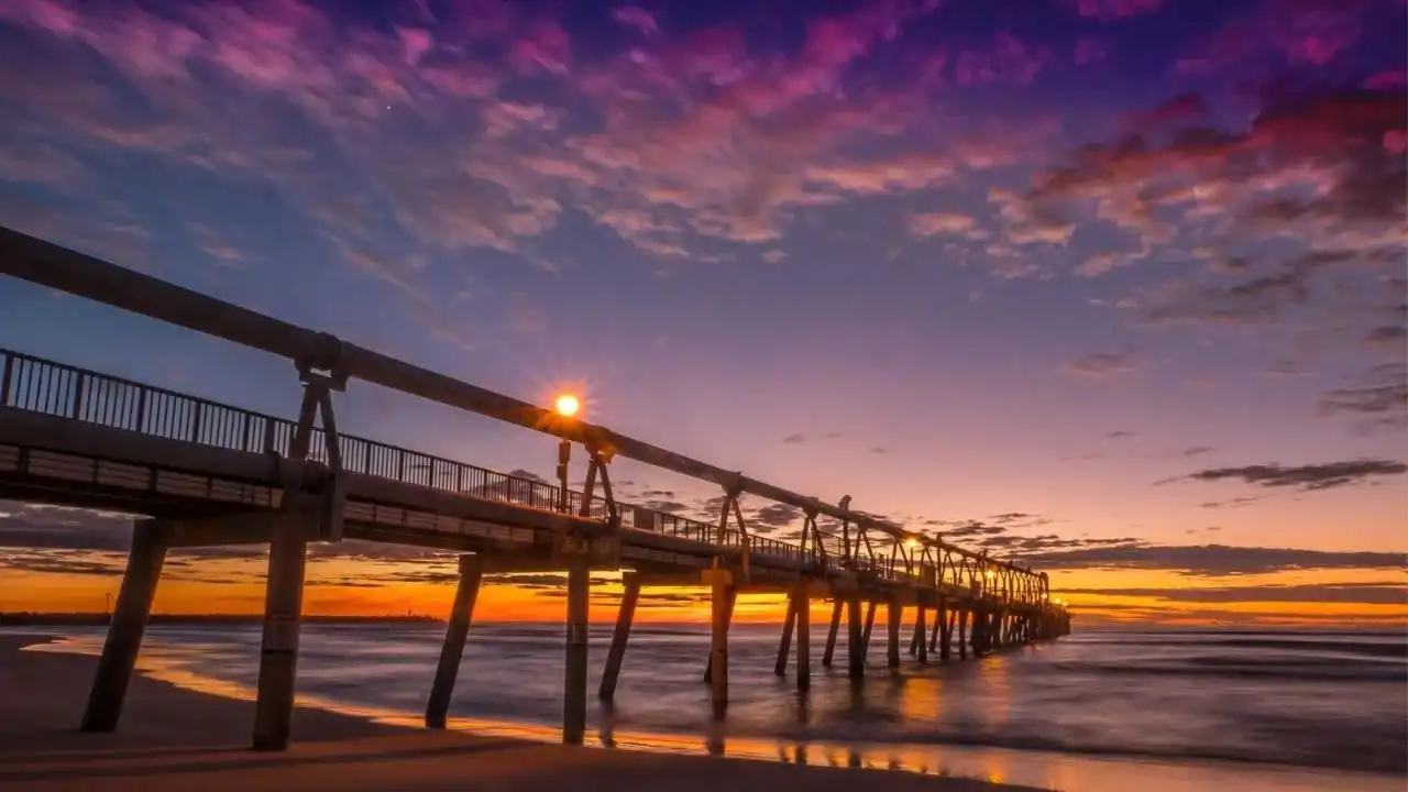 Sunset over the Sand Bypass Jetty at The Spit, Gold Coast, featuring purple and orange skies-a key inspiration for the Sunny Link premium collection.