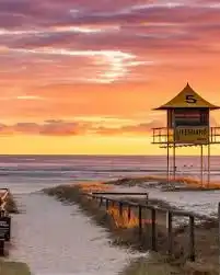 A coastal observation tower overlooking the sand; Sunny merch supports a network of community responders that complement existing beach safety efforts.